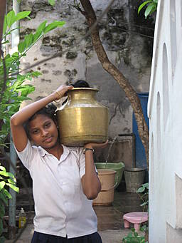 View larger image girl carrying water