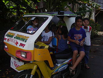 View larger image children in a motor-tricycle taxi